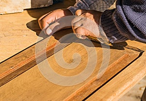 Manual restoration of old wooden door of a cabinet.