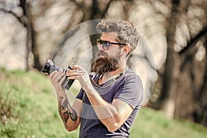 Manual settings. Photographer hold vintage camera. Modern blogger. Photographer with beard and mustache. Man shooting