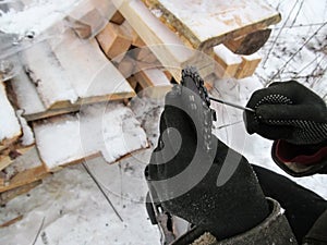 Manual sharpening chainsaw chains close-up - illustrative photo