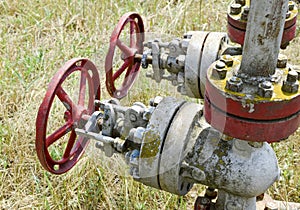 Manual shut-off valve on oil well. Oil well wellhead equipment.
