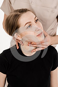 Manual therapy at physiotherapist or chiropractor. Orthopedist examining female neck and head. Manual correction of the