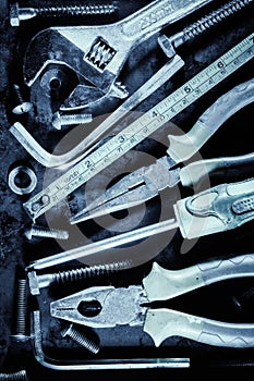Manual tools and screws with a metallic blue color