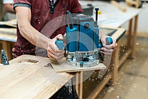 Manual wood concept. Cropped photo of cabinetmaker handyman stand half turn to camera hold electric tool in hand make furniture in