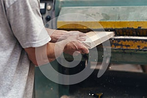 Manual wood small business concept. Cropped photo of cabinetmaker handcraft tradesman using woodworking machine stand in garage or