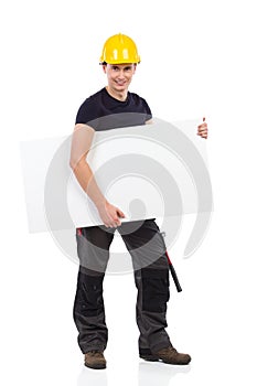 Manual worker carrying blank baner under his arm