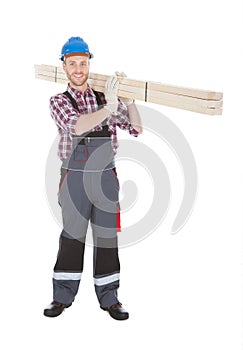 Manual Worker Carrying Wooden Planks