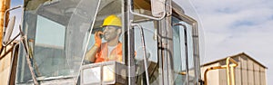 Manual worker driving cargo truck in plant