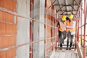 Manual Worker Helping Injured Colleague In Construction Site photo