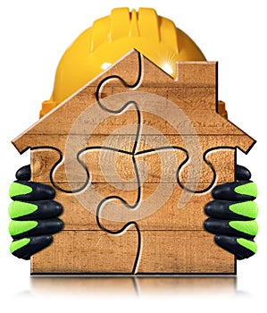 Manual Worker Holding a small Wooden House made of Puzzle Pieces