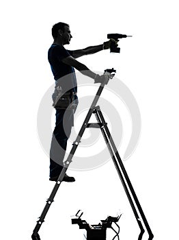 Manual worker man on stepladder drilling silhouette