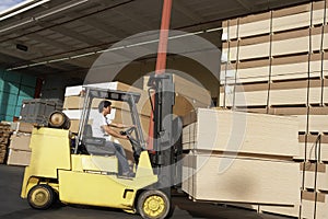 Manual Worker Operating Forklift Truck In Lumber Industry