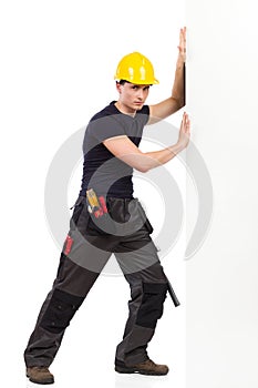 Manual worker pushing the wall