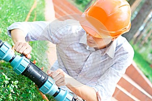 Manual worker repairing a pipe