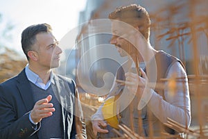 Manual worker talking to manager by rebars photo