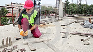 Manual Worker Using Hammer at Construction Site