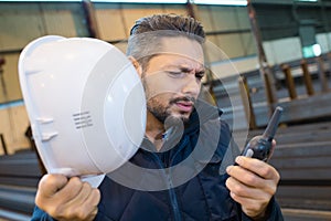 manual worker using walkie-talkie in metal industry