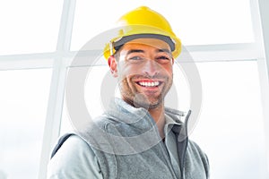 Manual worker wearing hardhat in building