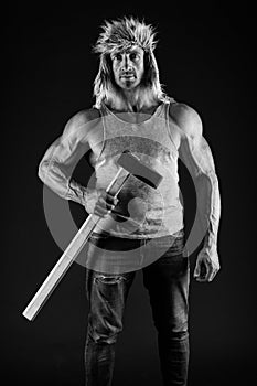 Manual worker. Worker hold hammer in strong arms. Athletic man black background. Construction and building. Physical