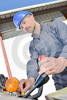 Manual worker working on machinery in metal industry