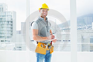 Manual worker writing on clipboard in building