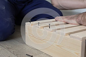 Manufacture and production of wooden products from boards and slats, close-up. Carpentry and production work