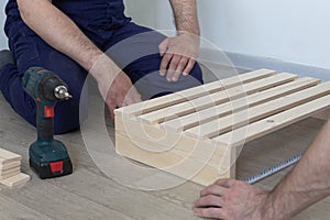 Manufacture and production of wooden products from boards and slats, close-up. Carpentry and production work