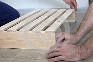 Manufacture and production of wooden products from boards and slats, close-up. Carpentry and production work