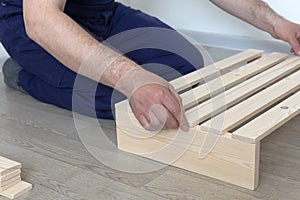 Manufacture and production of wooden products from boards and slats, close-up. Carpentry and production work