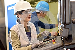 Manufacture workers setting up machines