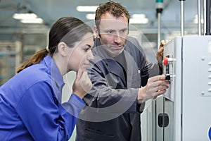 manufacture workers working on electronic machine