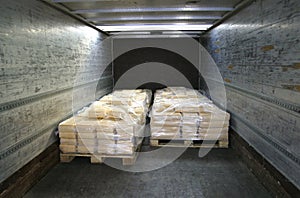 Manufactured cheese on pallets in back of truck