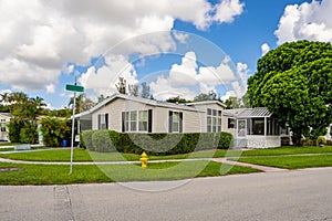 Manufactured homes with landscaped hedges and lawn