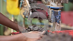 Manufactured or moulded incense cones drop from the conveyor belt at the factory