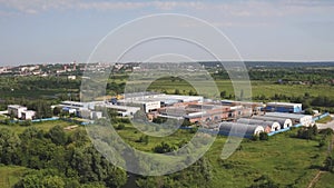Manufacturing area in field drone view. Aerial top down view of modern technology manufacturing plant. Aerial top view