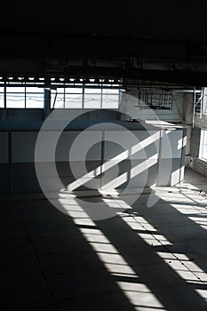 Manufacturing factory. Empty hangar building. Blue toned background. The production room with large windows and metal structures