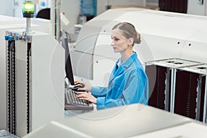 Manufacturing worker checking data of assembly line on screen