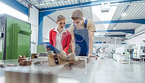 Manufacturing worker and manager during quality inspection