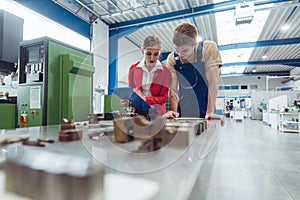 Manufacturing worker and manager during quality inspection