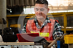 Manufacturing worker working with clipboard to do job procedure checklist .