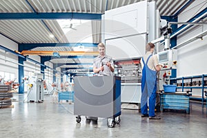 Manufacturing workers on the factory floor being industrious photo