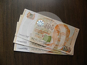 Many 100 dollars Singapore banknote