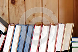 Many assorted old books casually lays in heap front view closeup