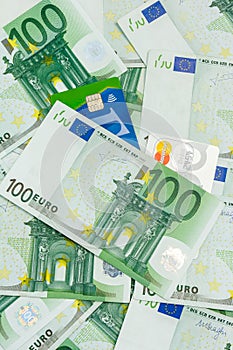 Many Banknotes of 100 Euro and Two Credit and Debit Cards, Pile of the European Currency Background