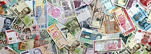 Many banknotes of different currency. Background of big amount of random money bills