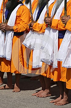 many barefoot men with the swords druing a sikh festival