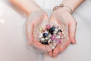 Many beautiful beads in the hands of a girl