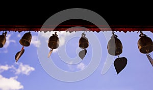 Many bell hanging against the background the blue sky