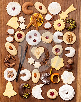 Many biscuits and spices on wooden background