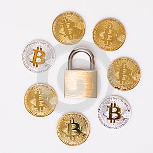 Many bitcoins with a close lock isolated white background
