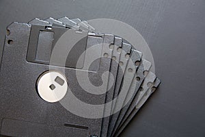 Many black computer diskette on dark background.